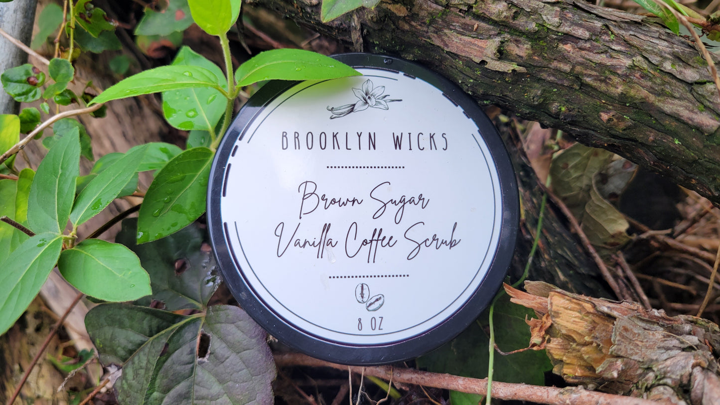 Jar of brown sugar vanilla coffee body scrub with visible texture, surrounded by natural ingredients like coffee beans and vanilla pods.